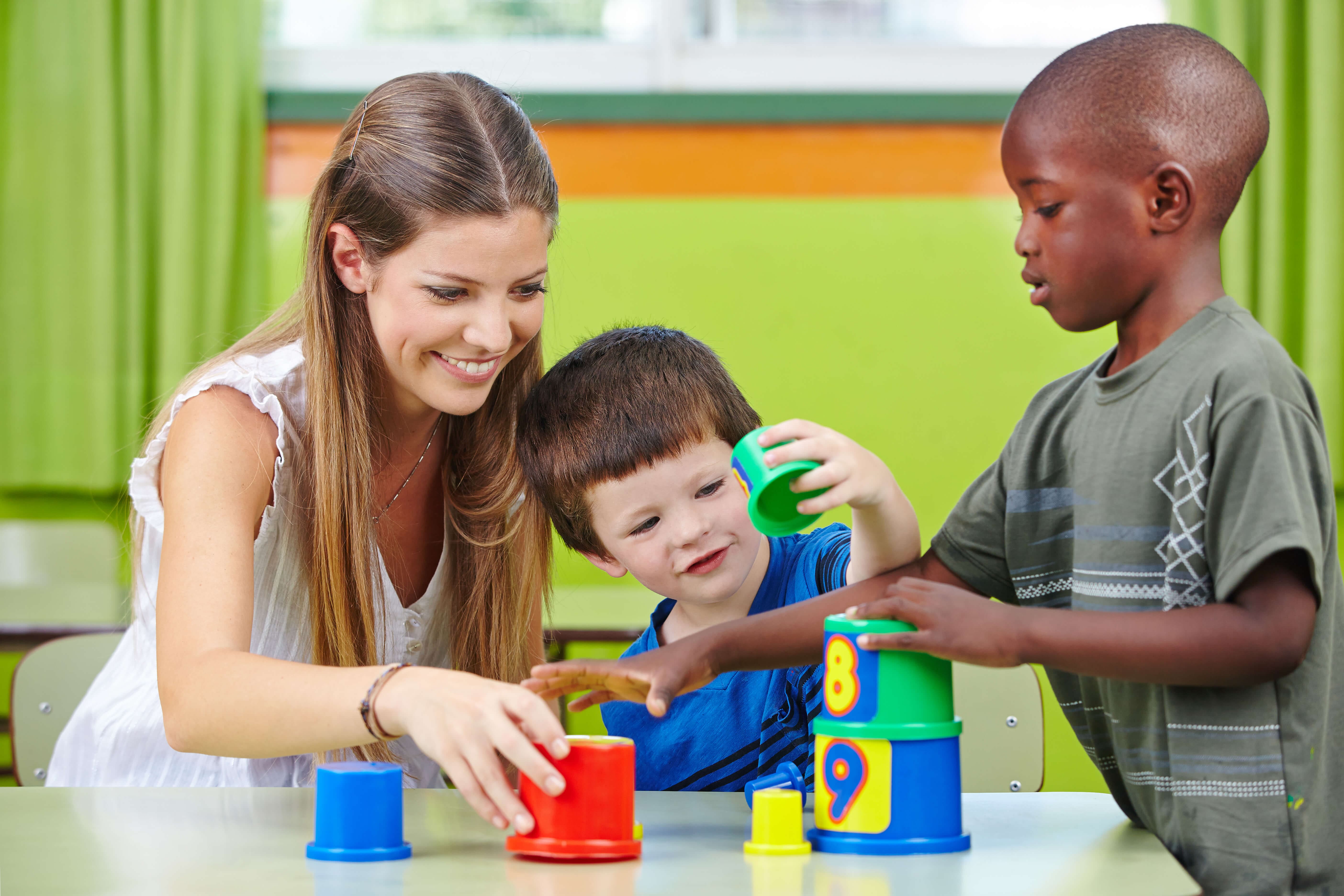 Woman and children playing with toys Woman and children playing with toys
