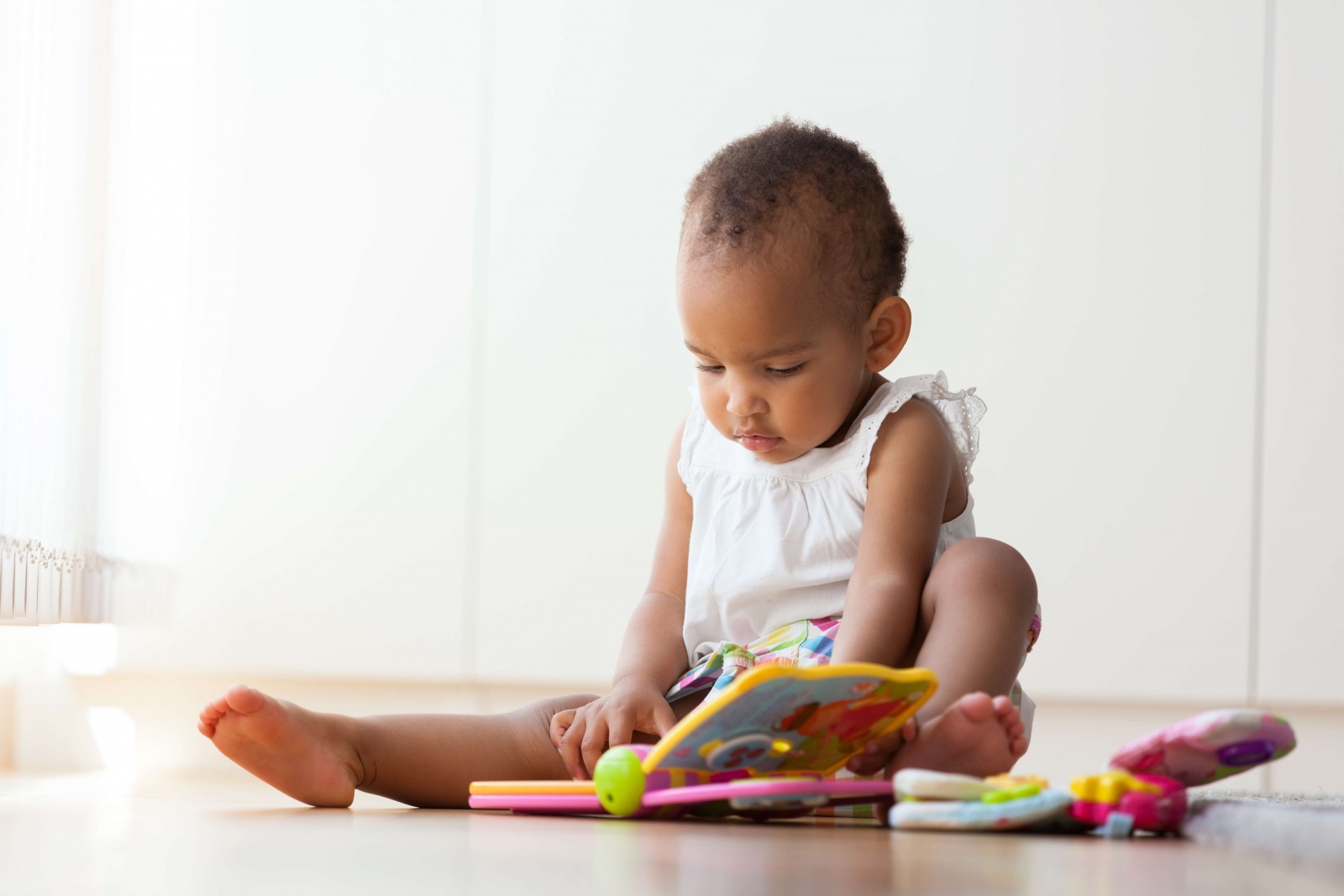 Baby reading a book on the floor Baby reading a book on the floor