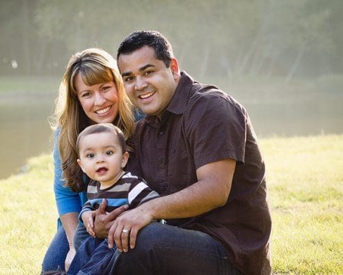 Parents and young child on the grass