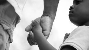 Boy and his father holding hands